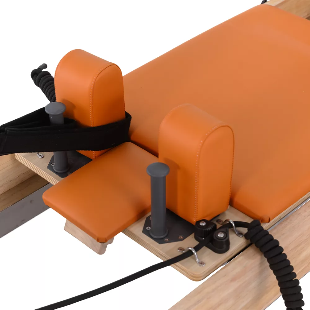 Orange shoulder rests and carriage detail on children Pilates reformer Orange shoulder rests and carriage detail on children Pilates reformer